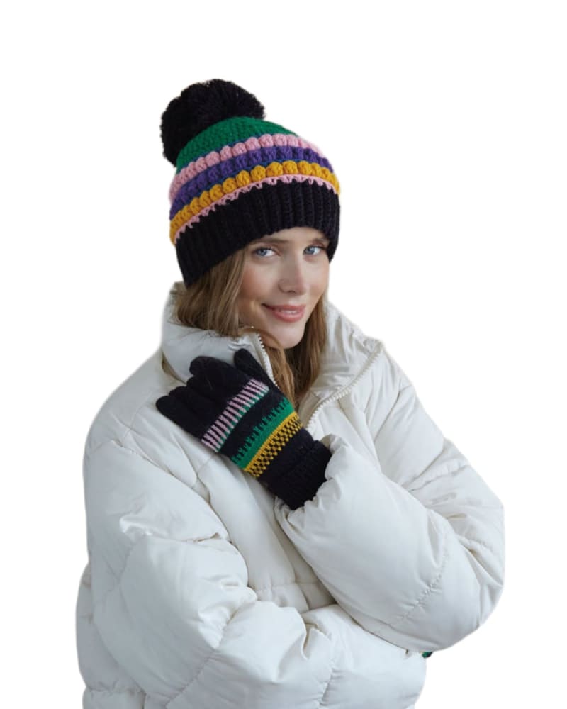 Side of a model wearing a size One Size Vargas Stripe Knit Winter Hat/Beanie in Black by Shiraleah. | dia_product_style_image_id:308974